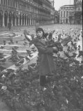 Venetian Woman Feeding a Hoard of Pigeons in the Piazza San Marco on a Rainy Day