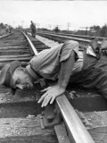 Railroad Section Boss D D Pittman Checking to Make Sure New Rail is properly level