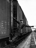 Railroad Brakeman George Christian  Swinging His Arm Horizontally to Signal to Locomotive Engineer
