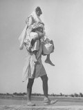 Sikh Carrying His Wife on Shoulders in Convoy Migrating to East Punjab After the Division of India