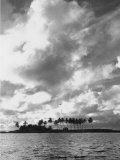 Sunset Darkened Clouds by a Clear Waning Light as Twilight Falls over a Sandy Beach and Palm Trees