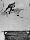 Ice Hockey Player Jean Beliveau  Slamming the Puck Into the Goal While He Slides Down the Ice