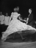 Whirling Hoop of Plastic Flaring Out Ruffled Skirt on Joan Davidson as She Dances with Frank Turner