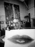 Painter Photographer Man Ray Holding Up "Lips" Print  Winking at Camera and Smoking a Pipe