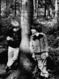Boys Standing Against Both Sides of the Tree Modeling Thick Winter Jackets and a Warm Pant Set