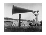 Man Blowing Bugle Into Large Megaphone  with Pitched Tents Behind Him  at US Naval Training Camp