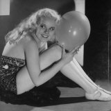 Joan Marsh  in Strapless Dress and Sitting on Floor Holding Balloon