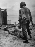 American Soldier Standing over Bodies of Japanese Attackers on Buna Beach