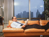 Fed Reserve Bd Chairman Appointee Alan Greenspan Stretched Out on Couch in His Apartment