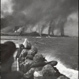 US Marines Crouched in Landing Boat  Looking at Bombardment of Beach Where They Are About to Land