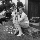 Robert Graves Sitting on Steps Dressed for Cricket