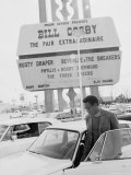 Comedian Bill Cosby Getting Into Car in Front of Sands Hotel Marquee with His Name on It