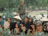 Marine Guarding Mostly Old People and Children Who Are Resting on Their Way to a Refugee Collection