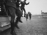West Berlin Police Officers Jump from Truck as Two Others Come Running to Start Guard Duty