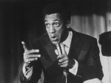 Comedian Bill Cosby Holding Mike as He Performs on Stage