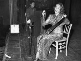 Marlene Dietrich Clad in Sequined Evening Gown Playing a Classical Number on a Saw with Violin Bow