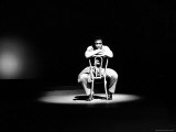 Boxer Joe Frazier Sitting on a Chair under a Spotlight
