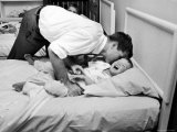 Bobby Kennedy  Chief Counsel of Sen Comm on Labor and Management  Tucks Son Joe into bed