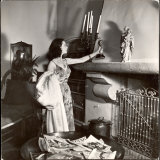 Vivien Leigh Placing Her Oscar on Her Mantelpiece at Home