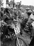 White Rider Preparing to Race at Mostly Black Motorcycle Enthusiasts