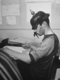 Hempstead HS Student sporting gear as He Writes in Class During "Old Clothes Day"