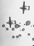 Scores of Paratroopers Dropping from C-82 "Flying Boxcar" and Landing on Level Ground