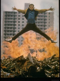 Riff Leaps over Smoldering Rubble of New York Slum Clearance Project in Scene from West Side Story