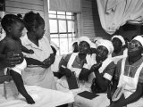 Nurse/Midwife Maude Callen Holds Baby and Teaches Class in Midwifery How to Look for Abnormalities