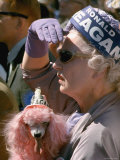 Female Holding Pink Poodle Wearing Hat Emblazoned with Reagan During Campaign Speech