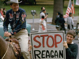 Ronald Reagan Riding Horse Near Man Holding Up Sign Emblazoned with Stop Reagan