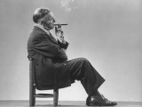 Architect Frederick Kiesler Seated in a Child's Chair  Smoking a Cigar  at Gjon Mili's Studio