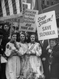 Czech Women Kneeling in Prayer During Protest Outside Hotel Hosting Peace Conference