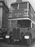 Double Decker Bus with White Tipped Bumpers and Large Eyes Painted on the Second Tier