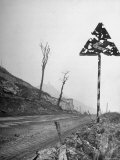 Road Sign Perforated by Shell Fragments Gives Mute Testimony to the Bitter Struggle