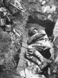 American Soldier of Mechanized Unit Sleeping in Foxhole Lined with Cardboard