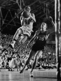 Burke Scott of Hoosiers Basketball Team Leaping Through Air Towards Lay Up Shot at Basketball Hoop