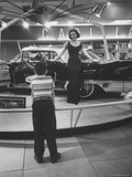 Model Posing Beside Cadillac Eldorado Captures Attention of Young Boy at National Automobile Show