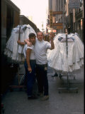 Workers with Racks of Clothing in Street at Garment District of New York City