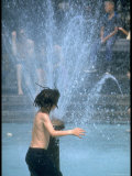 Children Cooling Off in the Spray of a Firehydrant on New York City Street