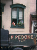 Woman Leaning from Her Window as an Ice Truck Drives by in New York City
