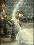 Children Cooling Off in the Spray of a Firehydrant on New York City Street