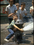 Children Cooling Off in the Spray of a Firehydrant on New York City Street
