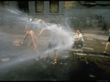 Children Cooling off in the Spray of a Firehydrant on New York City Street