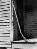 Old Rifle Leaning Up a Wall on the Porch of an Old House