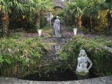 Lamorran House  Cornwall Formal Pond with Statues Cyprus  Trachycarpus  Osteospermum