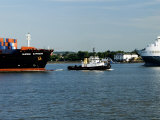 Tug Guiding a Containership Along the River Thames Near Tilbury  England