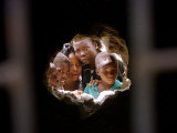 Young Nigerians Peer Through a Hole