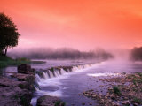 Sunrise in the morning mist over the waterfall on the Venta River near Kuldiga  Latvia