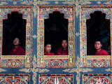 Buddhist Monks Look Through the Windows into the Courtyard of the Tango Monestary Near Thimphu