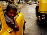 Taxi Driver Leaning Out Window As Motor Rickshaw Goes Past  Chowringee  India